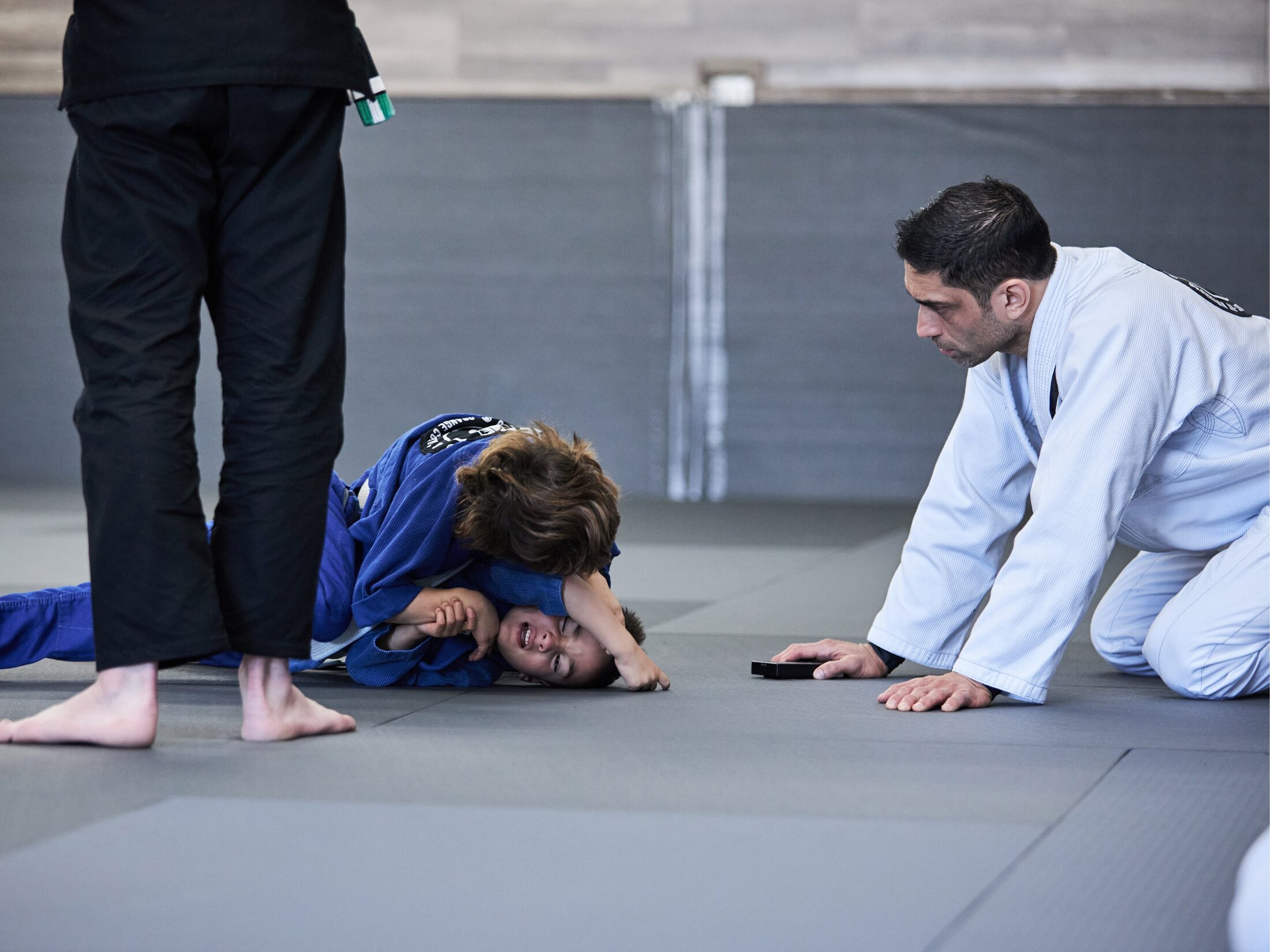 Young students drilling side control in a Little Phenoms kids Jiu Jitsu class at Phenom in Irvine